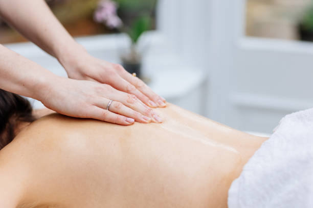 istock Young woman enjoying therapeutic massage in spa 2205590954