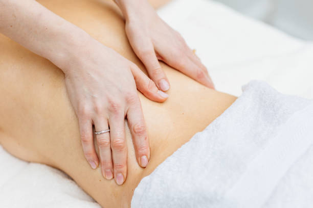 Young woman enjoying therapeutic massage in spa