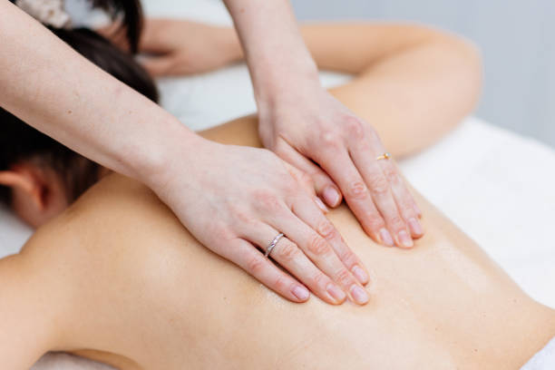 istock Young woman enjoying therapeutic massage in spa 2205590981