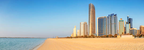 istock Panoramic view of modern skyscrapers towering over the sandy Corniche beach in Abu Dhabi, UAE, highlighting urban and natural beauty 2205591282