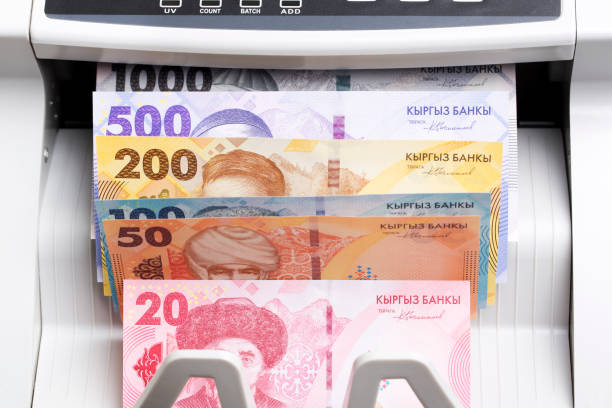 istock Kyrgystani Som in the counting machine 2205591387