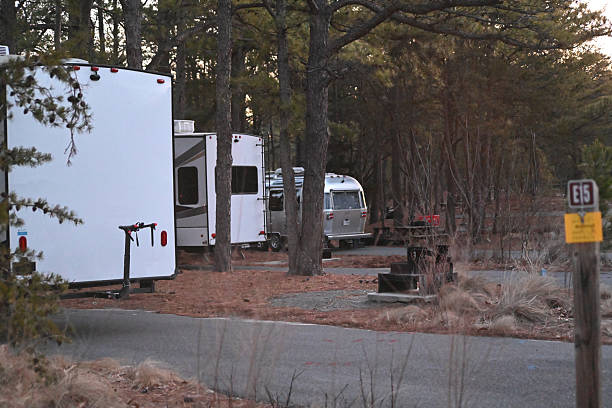 Line of RVs Campers at campground in fall during sunrise