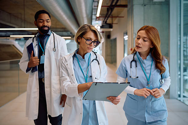 istock Group of medical experts analyzing reports in a hospital. 2205595636