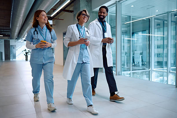 istock Multiracial group of happy doctors going on coffee break while working at medical clinic. 2205595652
