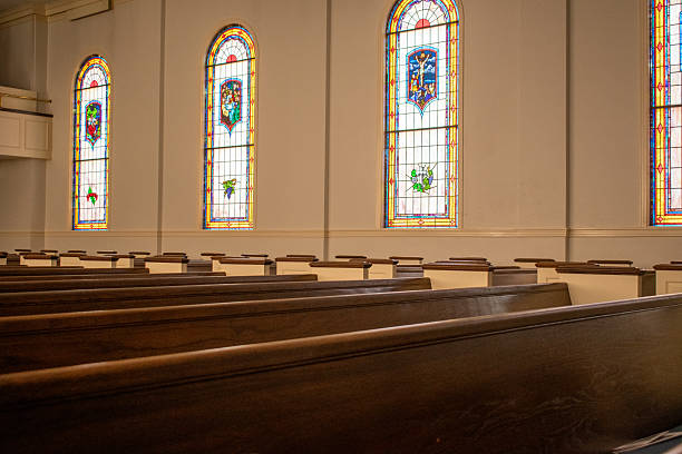 istock Interior church pews and stained glass windows 2205595917