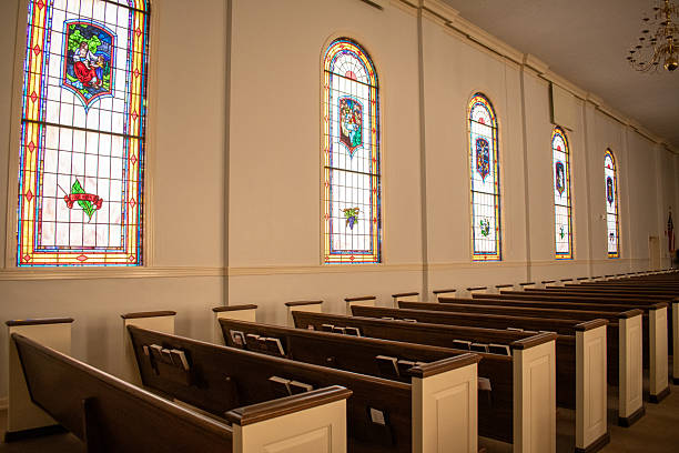 istock Interior church pews and stained glass windows 2205595924