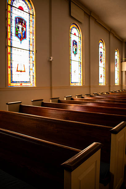 istock Interior church pews and stained glass windows 2205595937