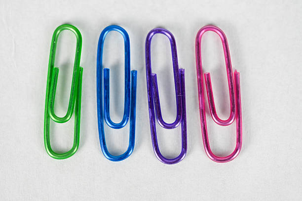 istock Close up brightly colored metal paper clips 2205596269