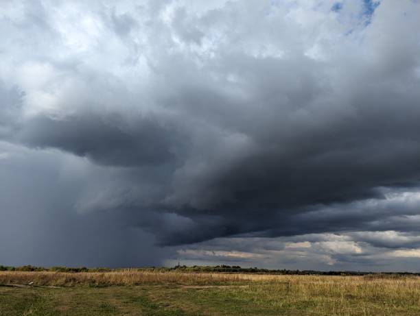 istock A Dramatic Stormy Sky Looms Over an Open Field, Creating an Engaging and Captivating Scene 2205596294