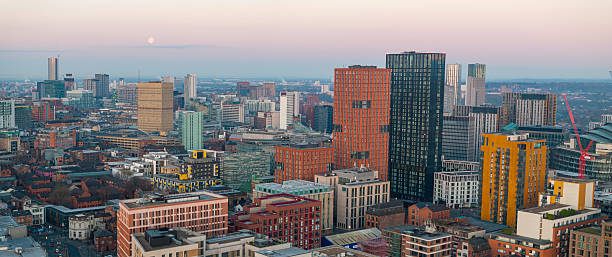 istock Manchester skyline Panorama with the Moon on the horizon. 2205596924