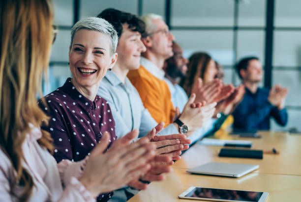 istock Businesspeople applauding during a seminar in conference hall. 2205598287