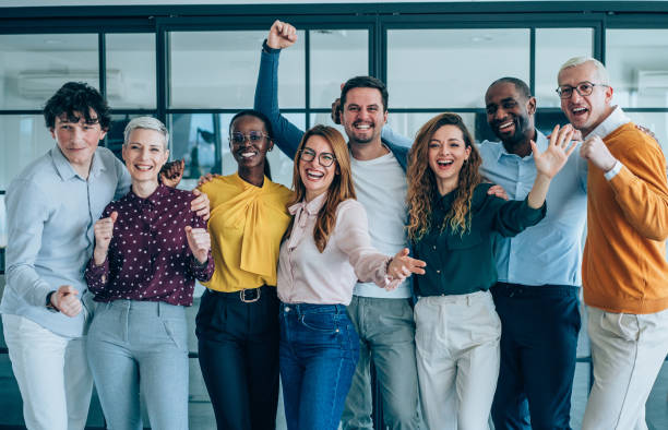 Cheerful entrepreneurs celebrating success in the office.