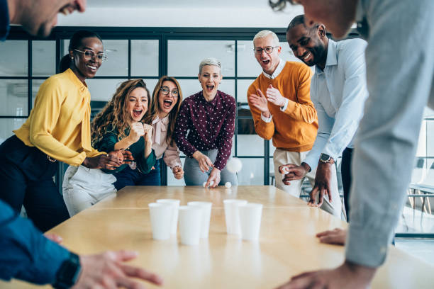 istock Young colleagues playing beer pong in the office. 2205598319