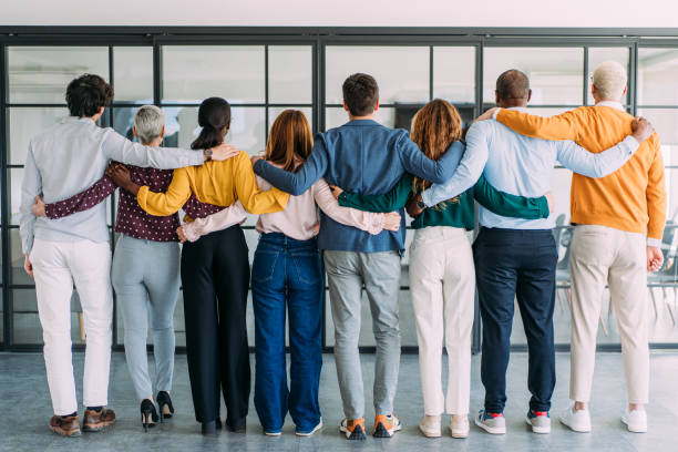 istock Back view of embraced business team in the office. 2205598348