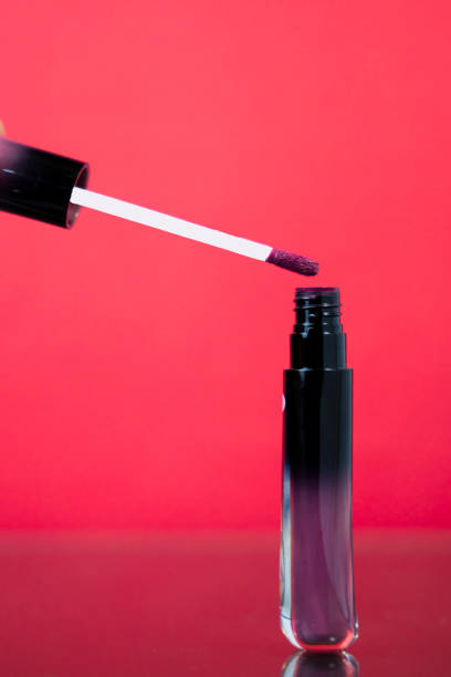 istock Pink Lip Gloss Bottle Isolated on Pinkish-Red Background 2205598494