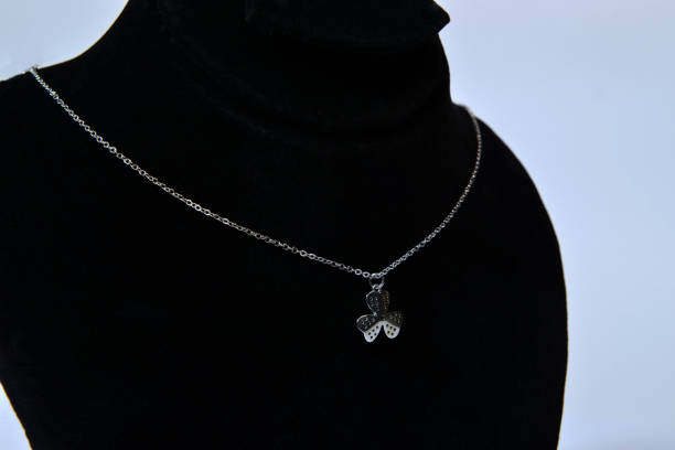 istock A side view of a leaf style silver necklace on a jewelry display bust 2205599222