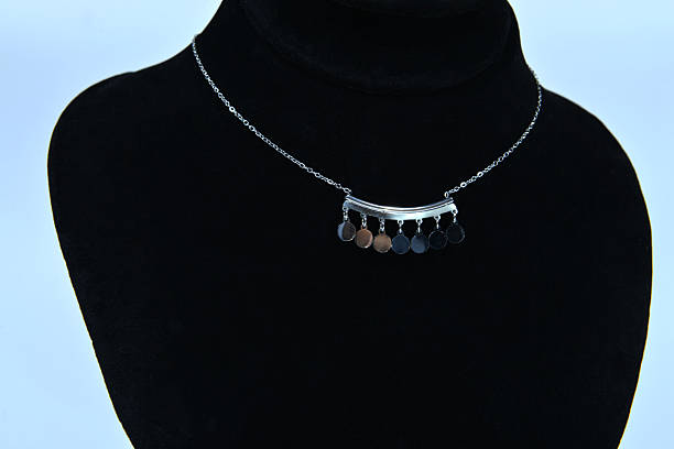 istock A silver minimal necklace, on a jewelry display bust 2205599486