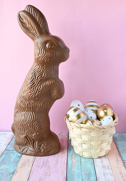 istock Chocolate rabbit symbol Easter holidays on a pink background. 2205599554