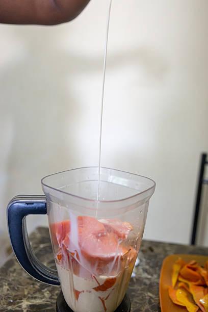 istock A woman preparing papaya juice 2205600536