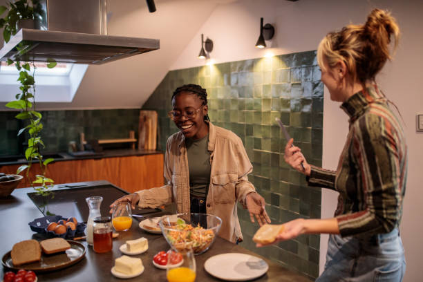 istock Women Friends Creating Delicious Meals in the Kitchen 2205601363