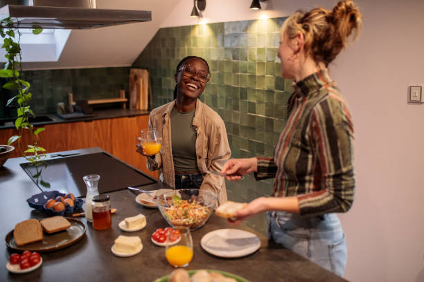 istock Women Friends Creating Delicious Meals in the Kitchen 2205601384