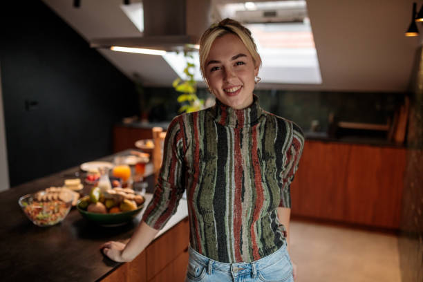 istock Young Woman Standing in Kitchen 2205601988