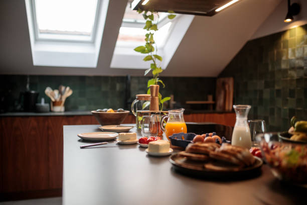 Modern kitchen in a cozy apartment, showcasing a selection of diverse foods on the counter, highlighting the balance of style and practicality in the space.