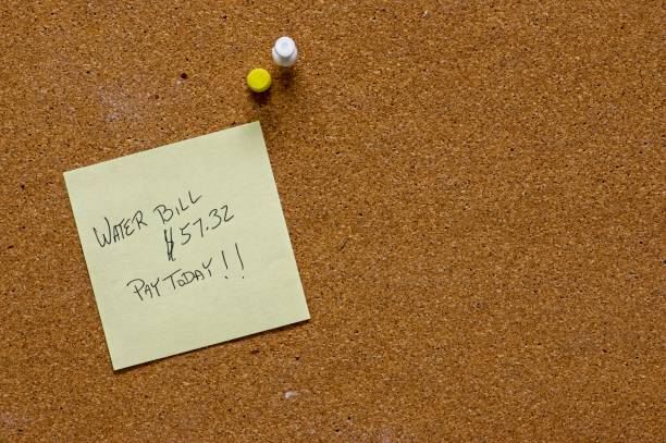 istock Sticky note on cork to remind for water bill 2205603929
