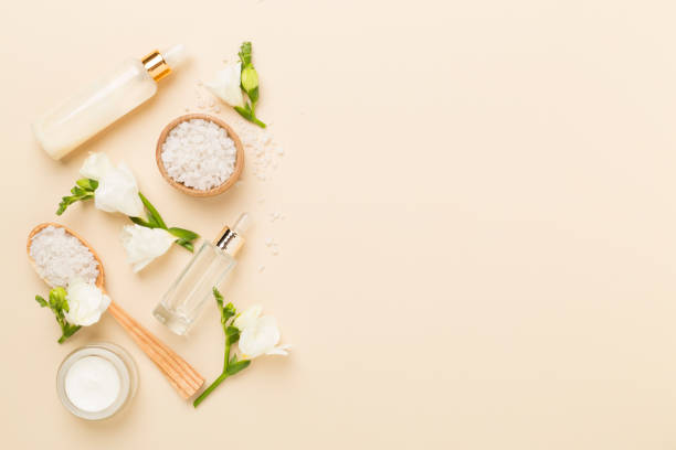 istock Flat lay with spa products and flowers on color background 2205605552