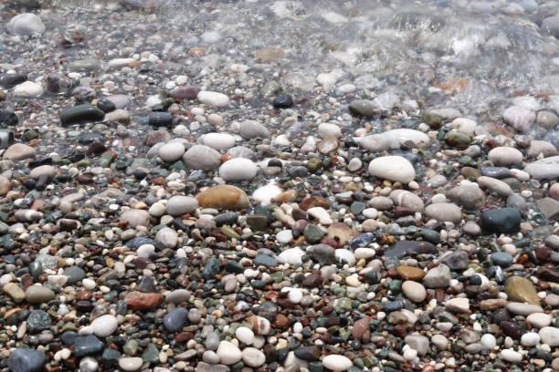 istock Multicolored sea pebbles on the seashore 2205606264