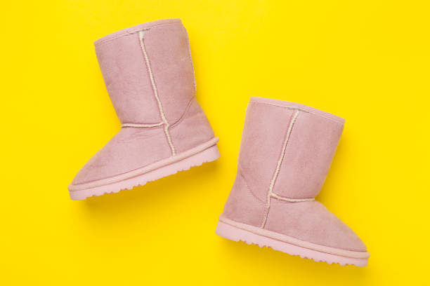 Beautiful boots on color background,top view