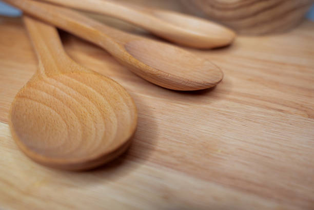 istock Wooden kitchen utensils on a rustic wooden surface 2205607586
