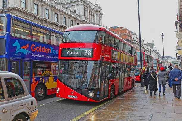 London, UK - September 12, 2024: Panning of A double-decker bus passing Oxford Circus in London at dawn