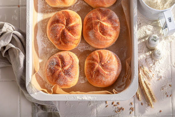 istock Healthy and tasty crispy kaiser buns in rustic bakehouse. 2205610071