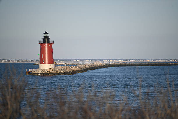 istock Delaware Breakwater East End Lighthouse Cape Henlopen Historic Red and White nautical light in early morning light 2205612322