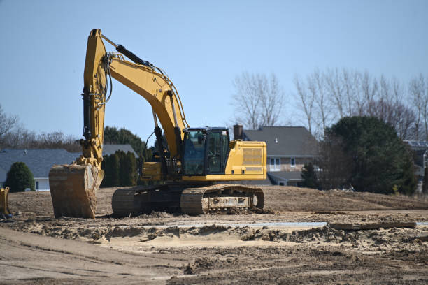 istock Yellow excavator digger construction vehicle on a construction site 2205612738