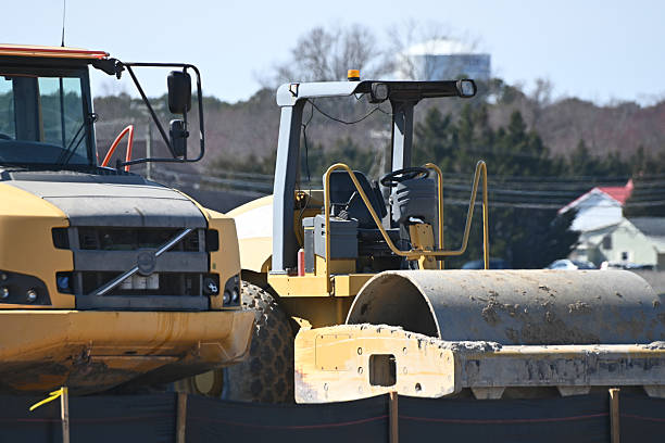 istock Yellow Construction equipment dump truck and steam roller in construction site 2205612741