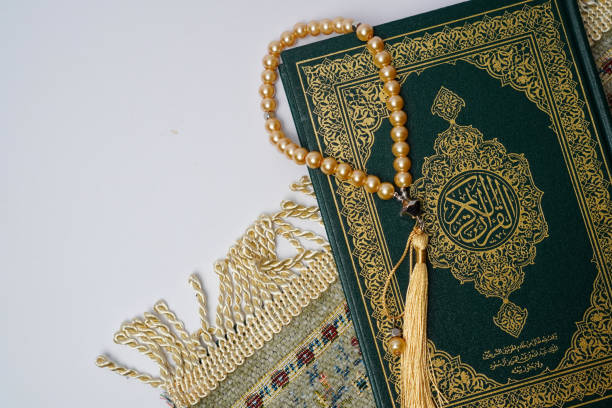 istock Holy Quran with Prayer Beads on a Prayer Rug 2205614413