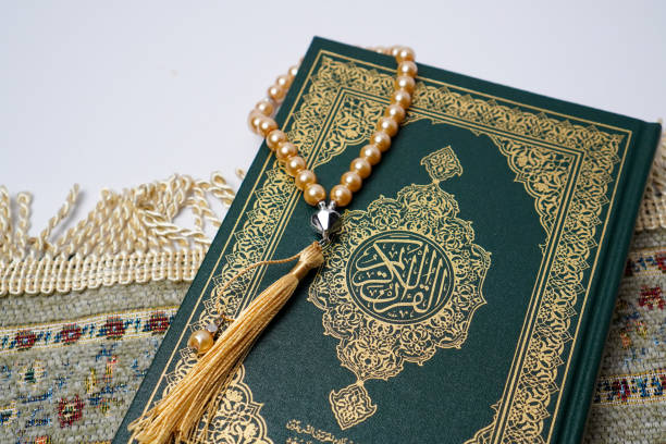 istock Holy Quran with Prayer Beads on a Prayer Rug 2205614423
