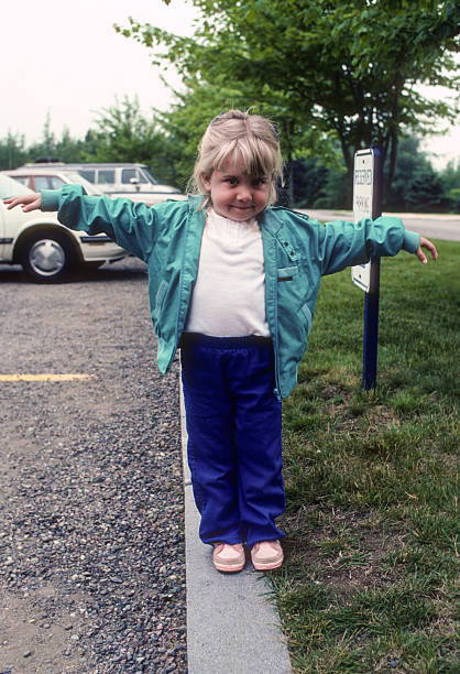 istock Girl on Curb - 1985 2205614587