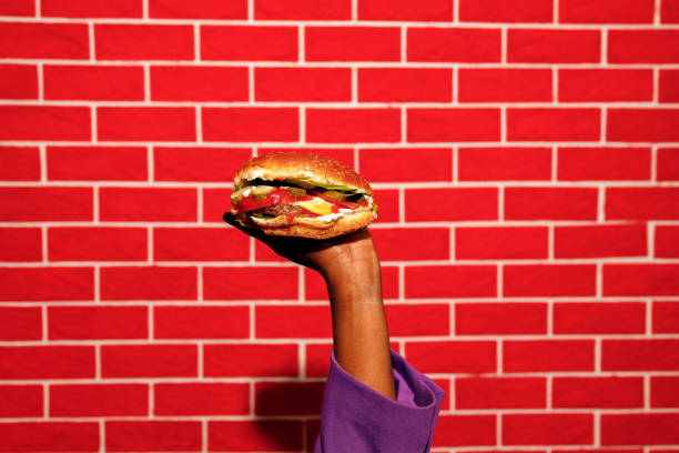 Young woman enjoys hamburger at cafe