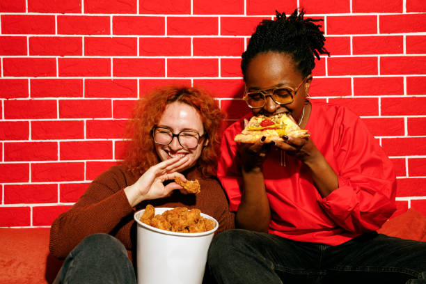 Two Friends Laughing and Enjoying Fast Food