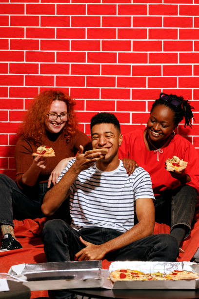 istock Friends Enjoying Pizza Together 2205615910