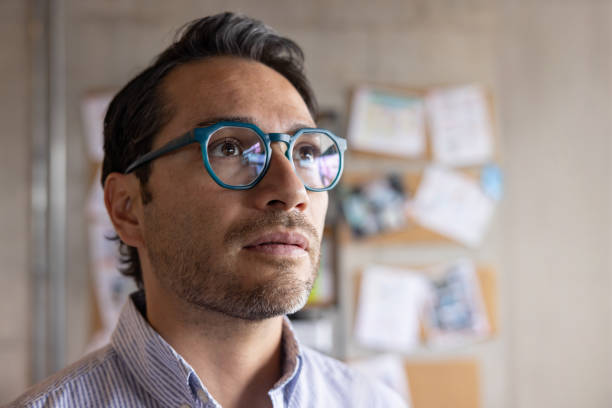 istock Businessman thinking at the office and looking away 2205617516