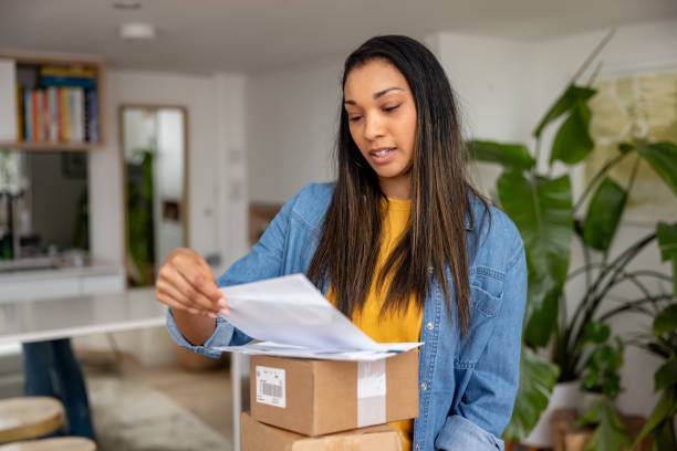 istock Casual woman at home checking her mail 2205618105