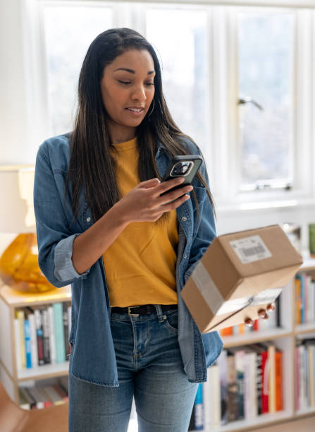 Woman confirming the arrival of a package scanning a code with her cell phone