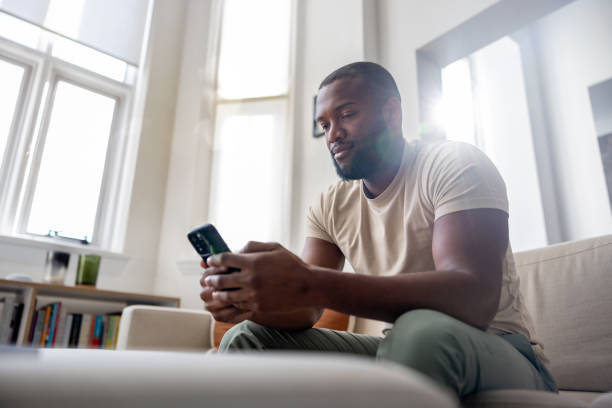 istock Man at home texting on his cell phone 2205618121