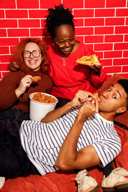istock Friends Enjoying Fast Food Together 2205622451
