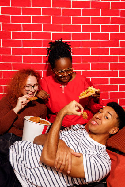 istock Friends Enjoying Fast Food Together 2205622470