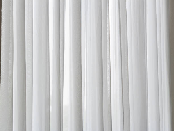 istock Elegant white drapes soft natural light indoor space calm atmosphere close-up home decor inspiration 2205626103